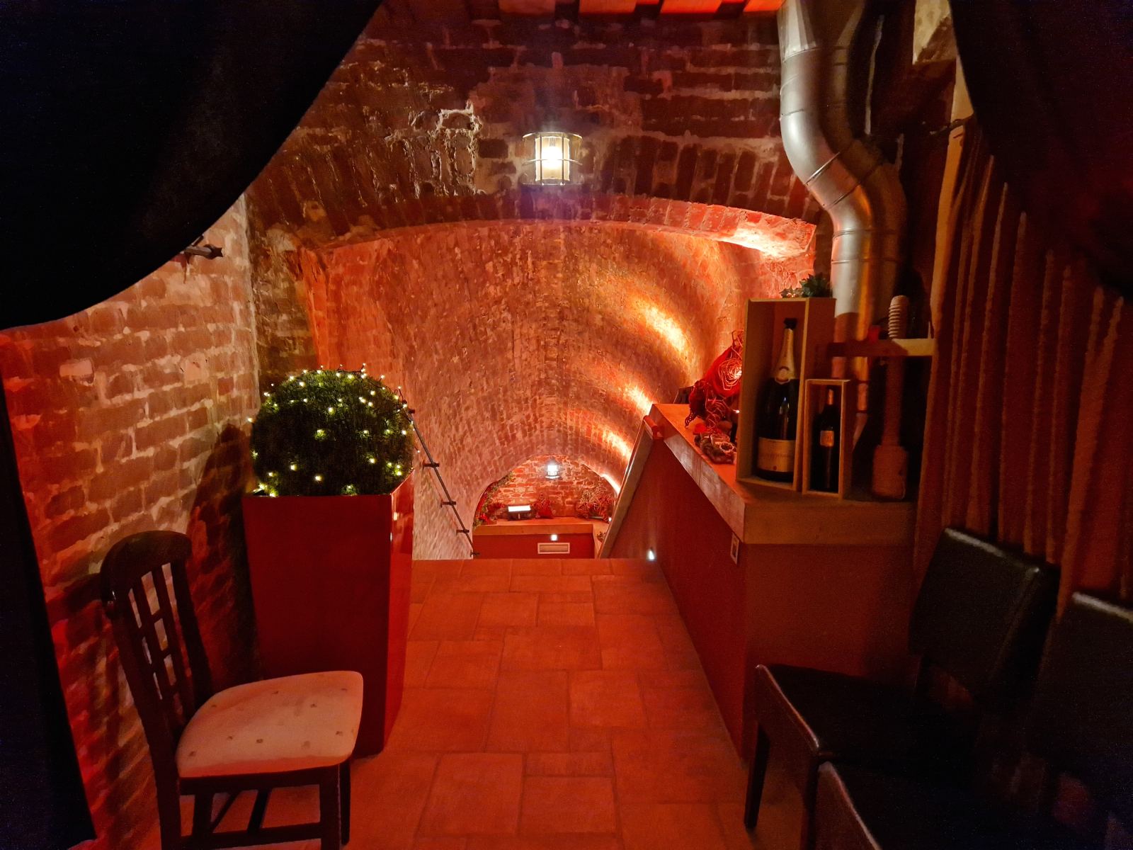 Wine shelf by the stairway to the vaulted cellar