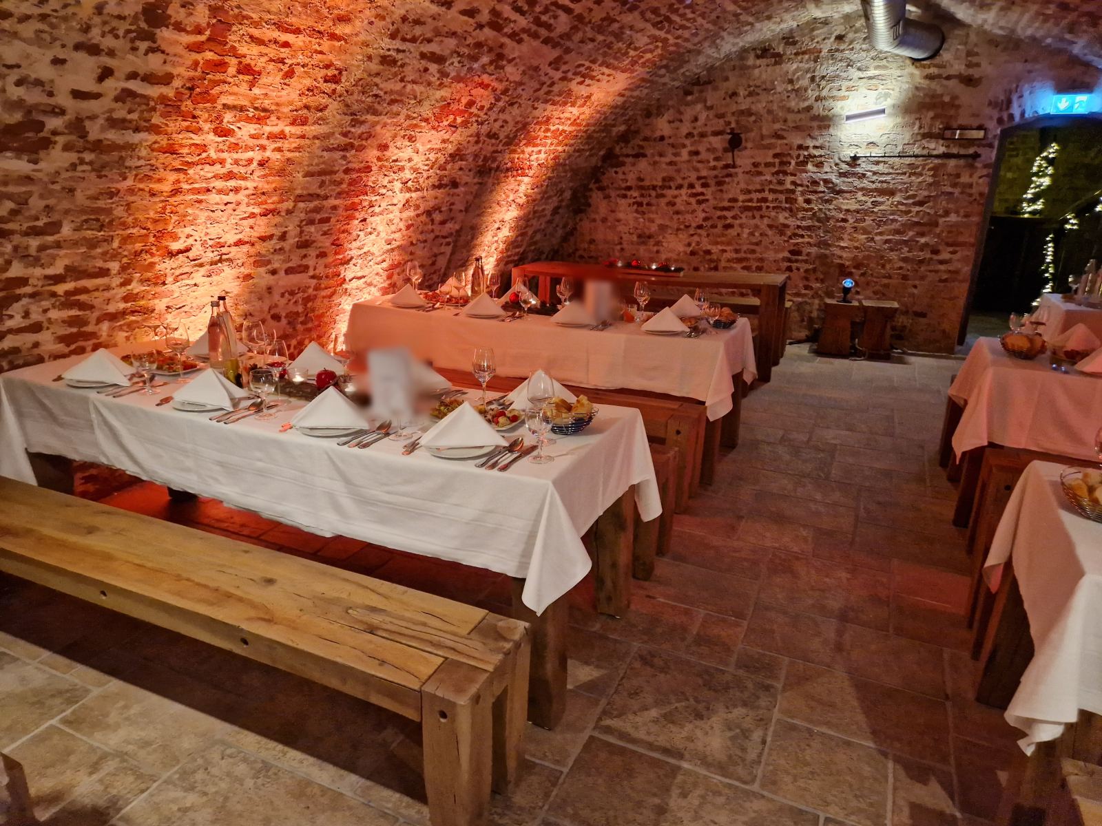 Laid tables with starters in the vaulted cellar